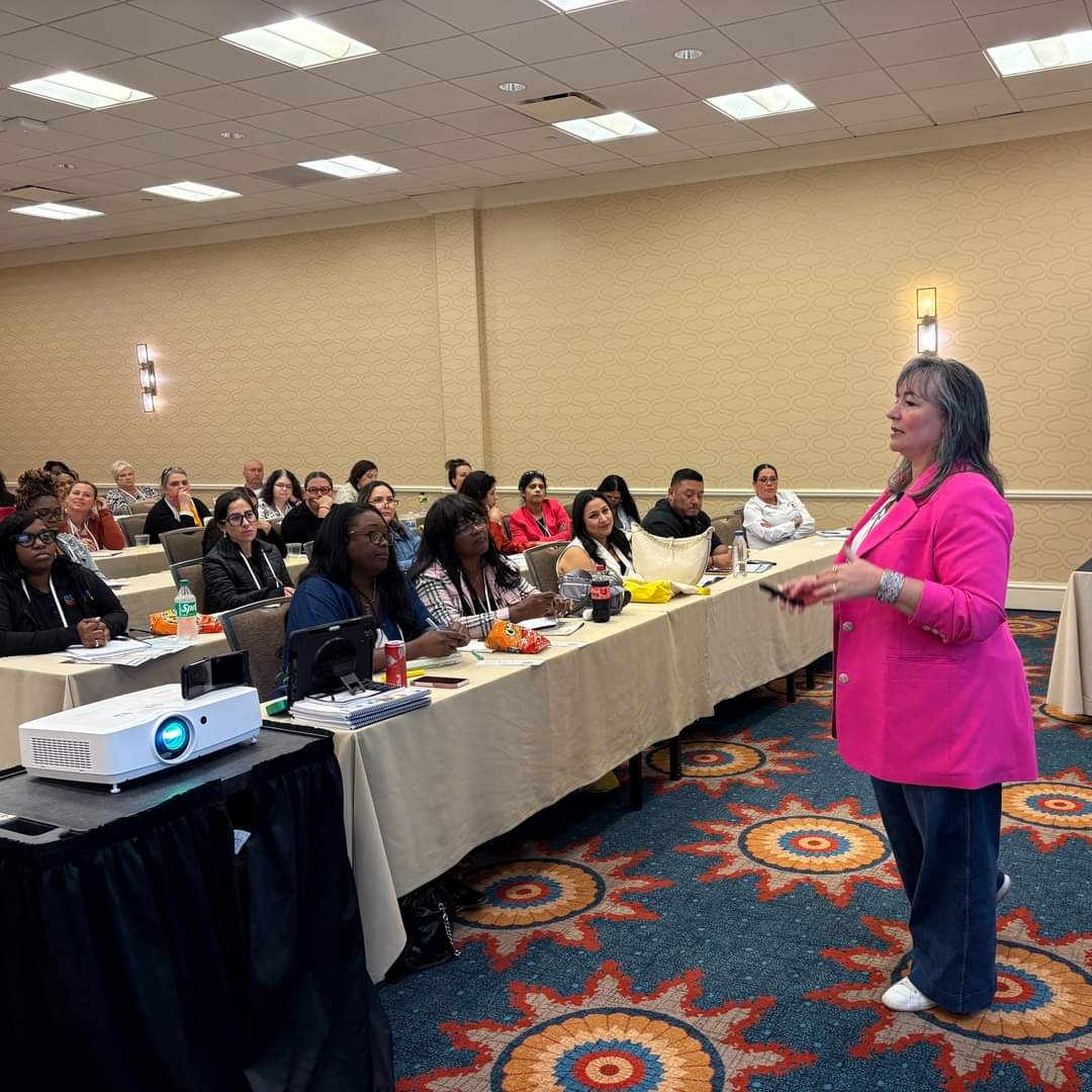 Kate engaging the audience while speaking at a conference